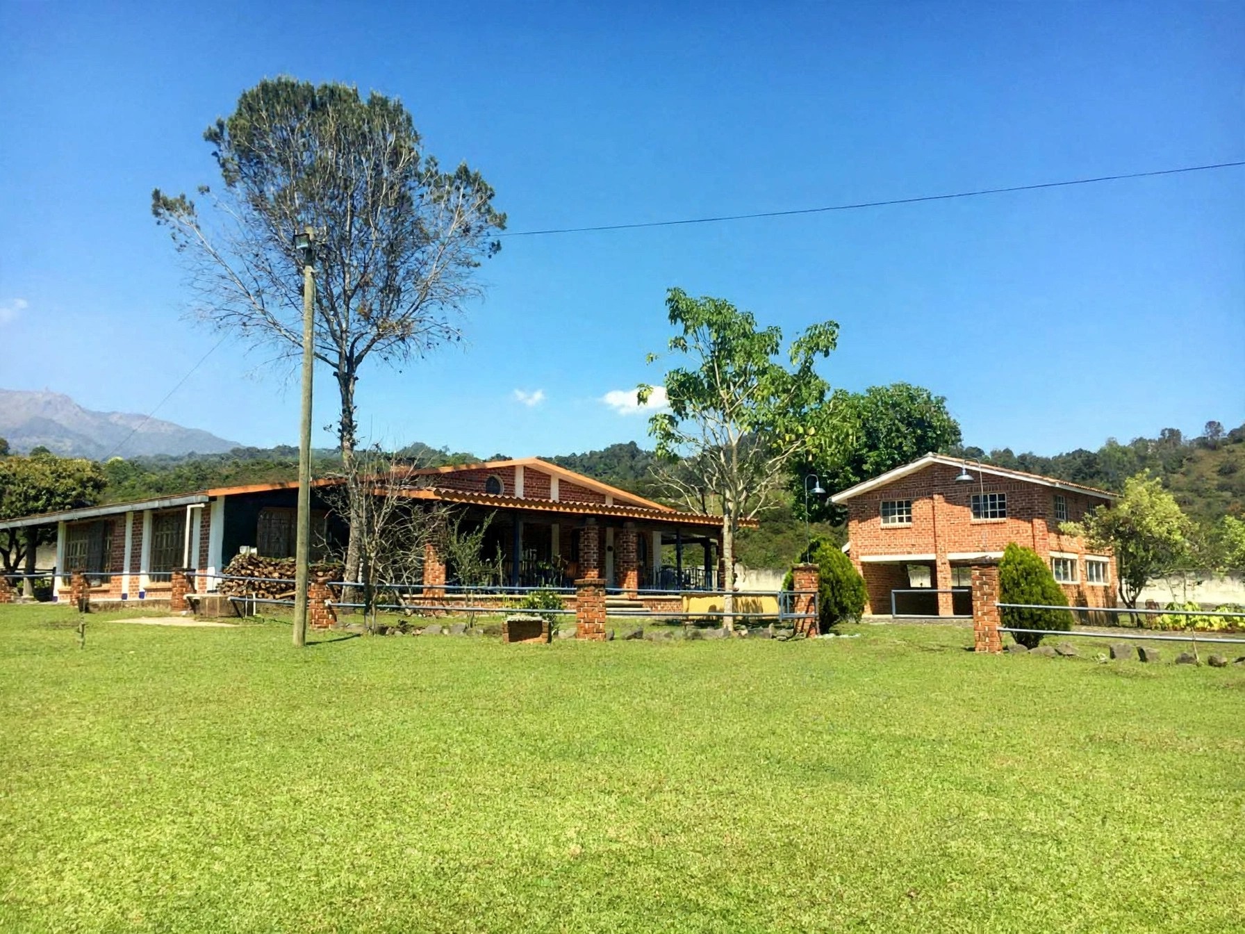 Main house and guest house across the wide lawn at Quinta San Gabriel