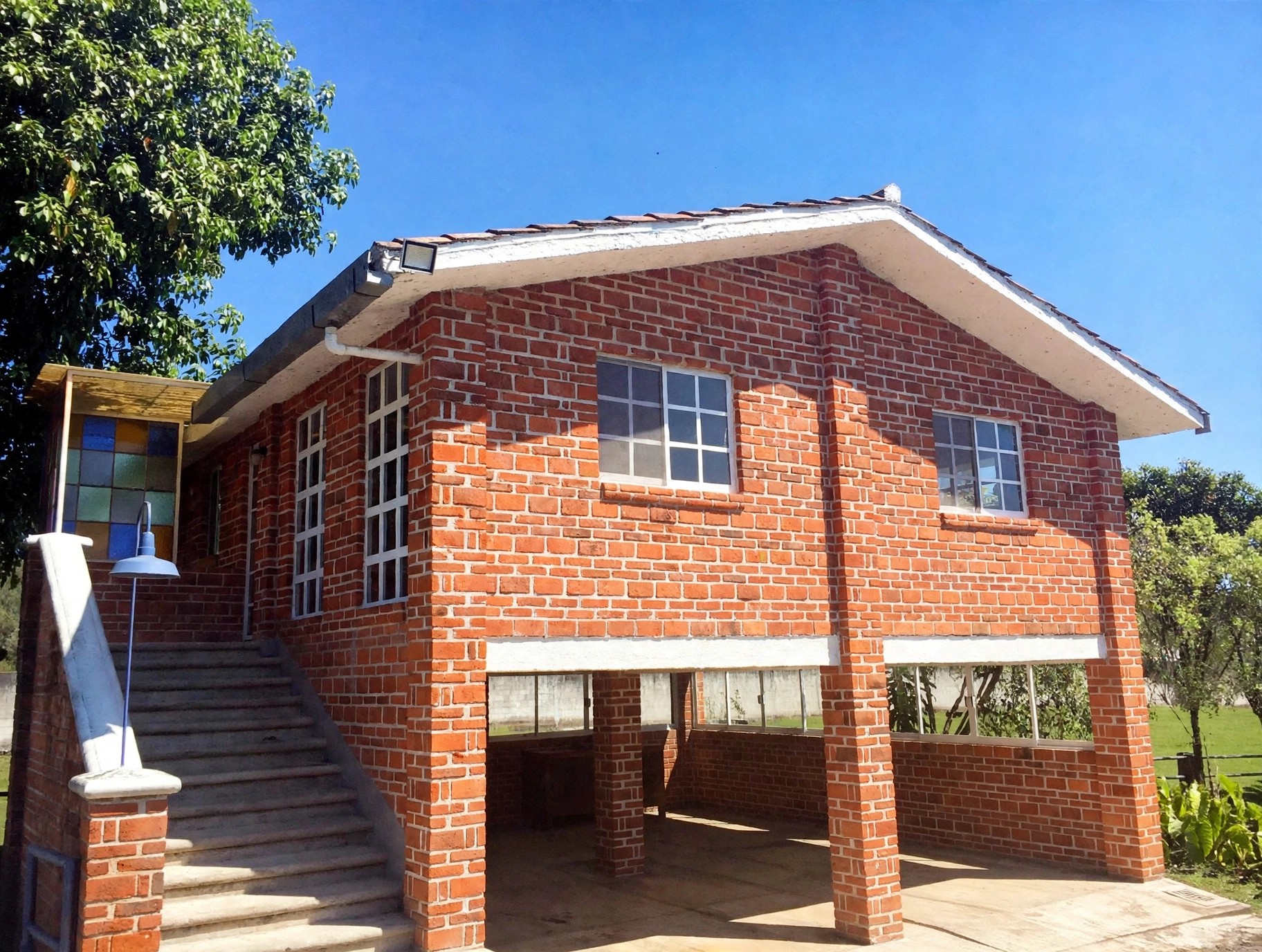 Two-storey guest house exterior with parking underneath